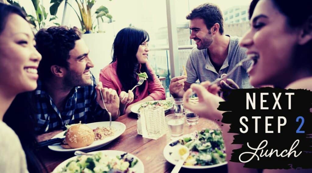 Next Steps Lunch 3. Five young adults having lunch together looking happy. Eating salad.