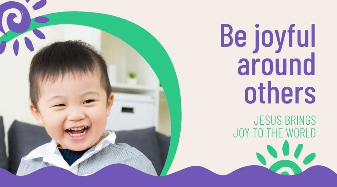 Be joyful around others. Happy young boy about two years old. Wearing a grey shirt.