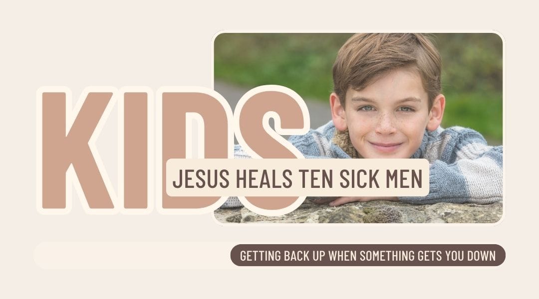 Image of a five year old boy wearing a jumper outside leaning on a stone wall smiling.