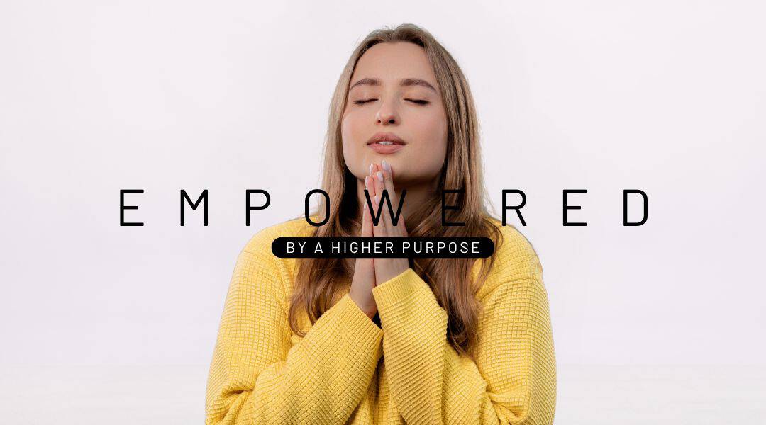 Image of a young twenty year old lady wearing a bright yellow jumper praying with her eyes shut. Empowered by a higher purpose.