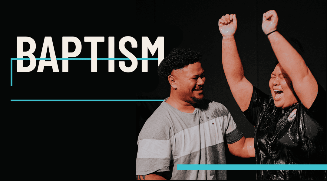 Image of a couple in their late twenties. The lady has her hands in the air with a huge smile on her face with the man looking at her with such joy after getting baptised.