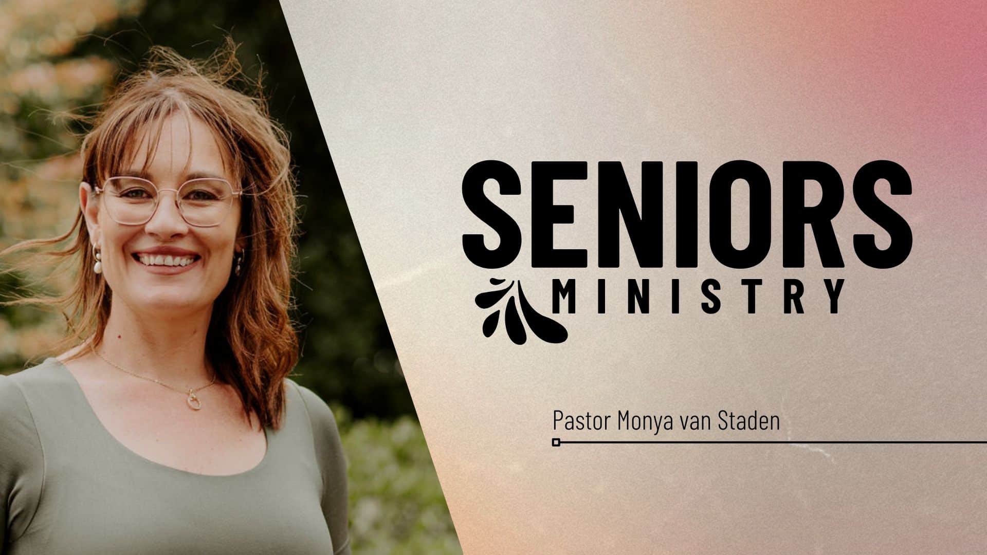 Image of Pastor Monya with brown curly shoulder length hair, gold glasses wearing a green long sleeve top