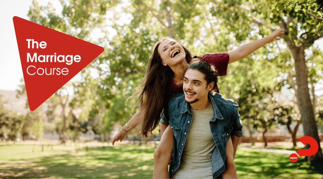 Happy couple in a park with lady being piggybacked on her husbands back. Title THe Marriage Course.