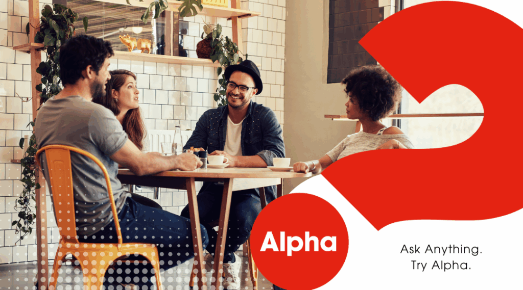 Group of four young adults sitting at a table. Two women and two men.