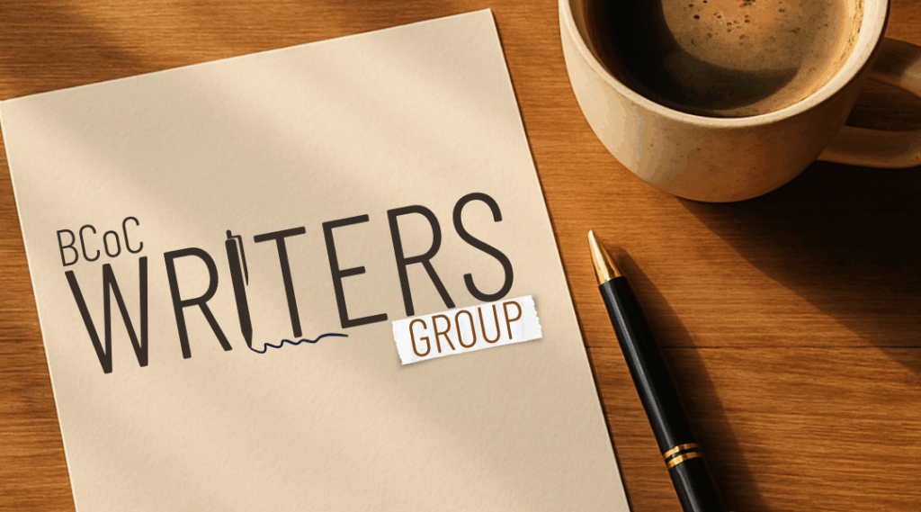 Warm timber table with notepad and cup of coffee. Pencil sits beside the notepad with the title, BCOC Writers Group.