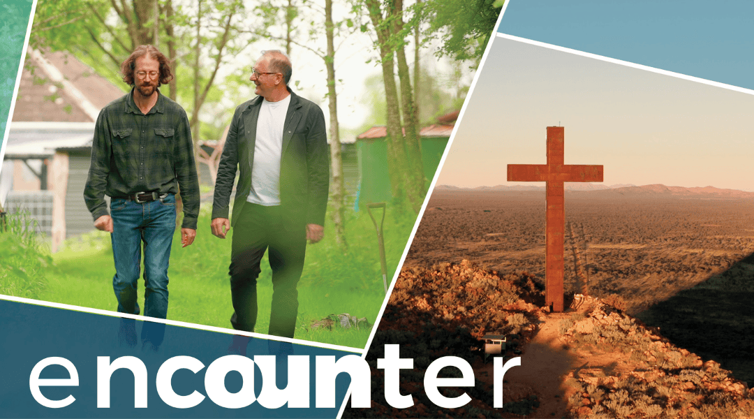 Karl and a man walking in a paddock. Rusty large cross standing on a mountain in Australia. Title: Encounter.
