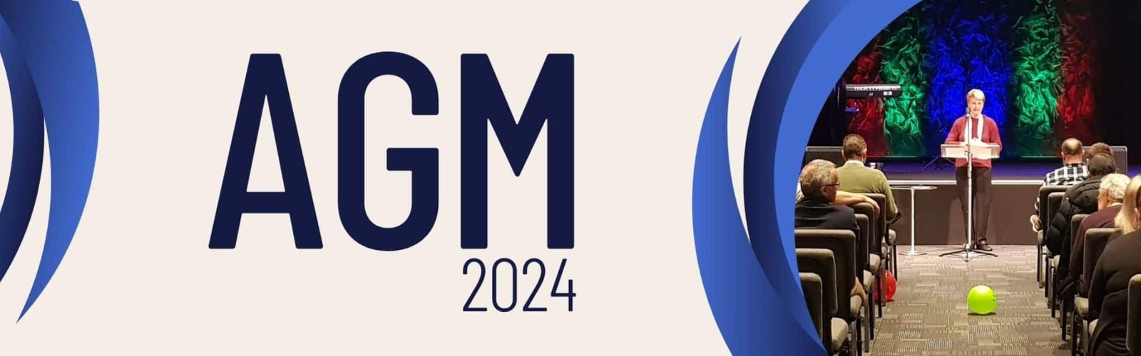 Image of Chair Glenda presenting at the AGM 2024 infront of people sitting.