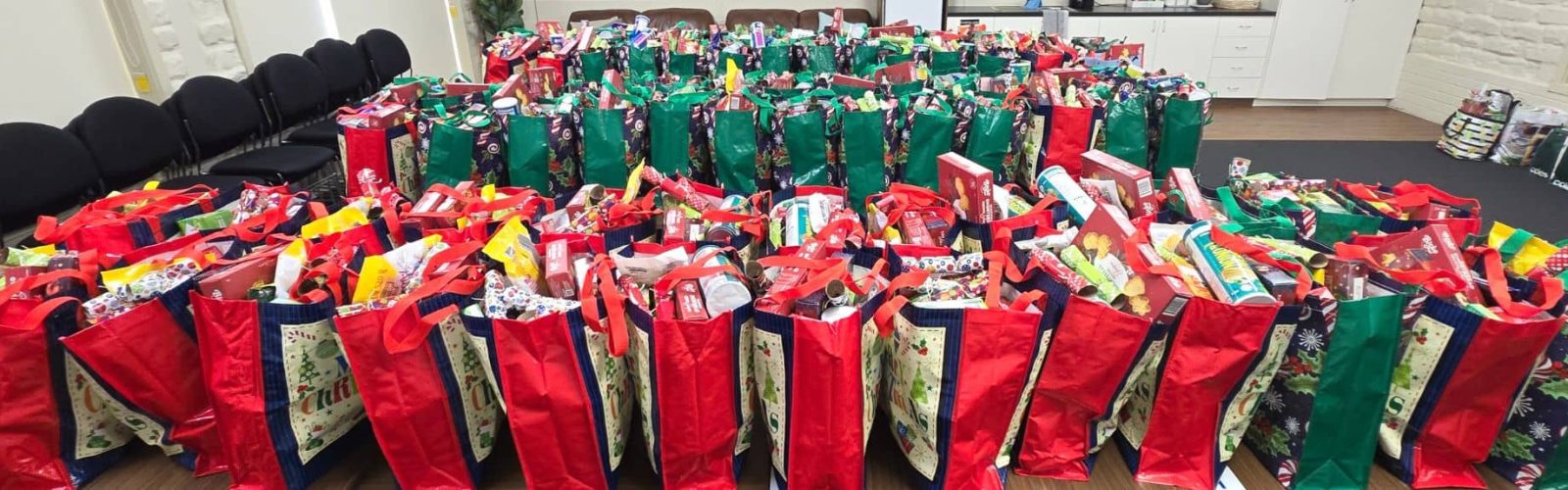 Image of one hundred Christmas hampers ready to be given away