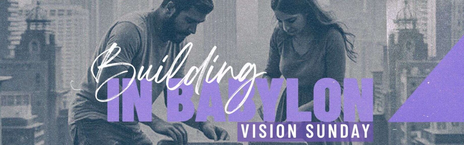 Image of a man and women stacking bricks with a city behind them