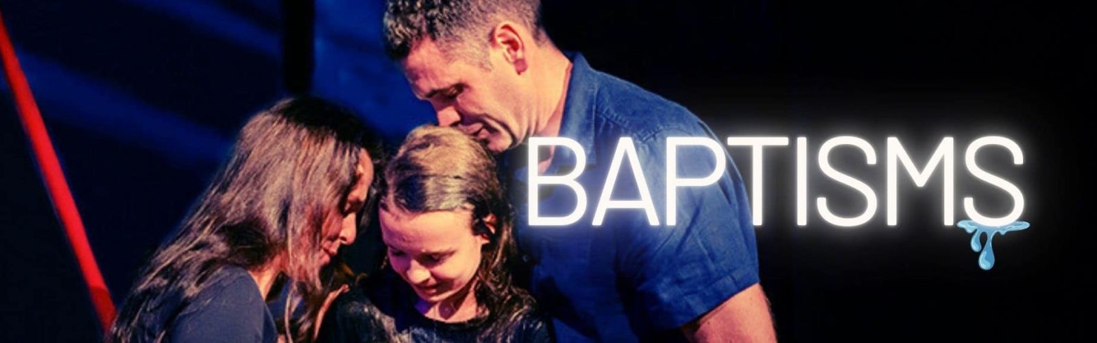 Image of a mother and father hugging their daughter who just got baptised.