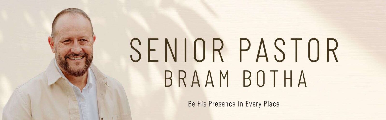 Image of Braam wearing a beige jacket, white shirt with a beard