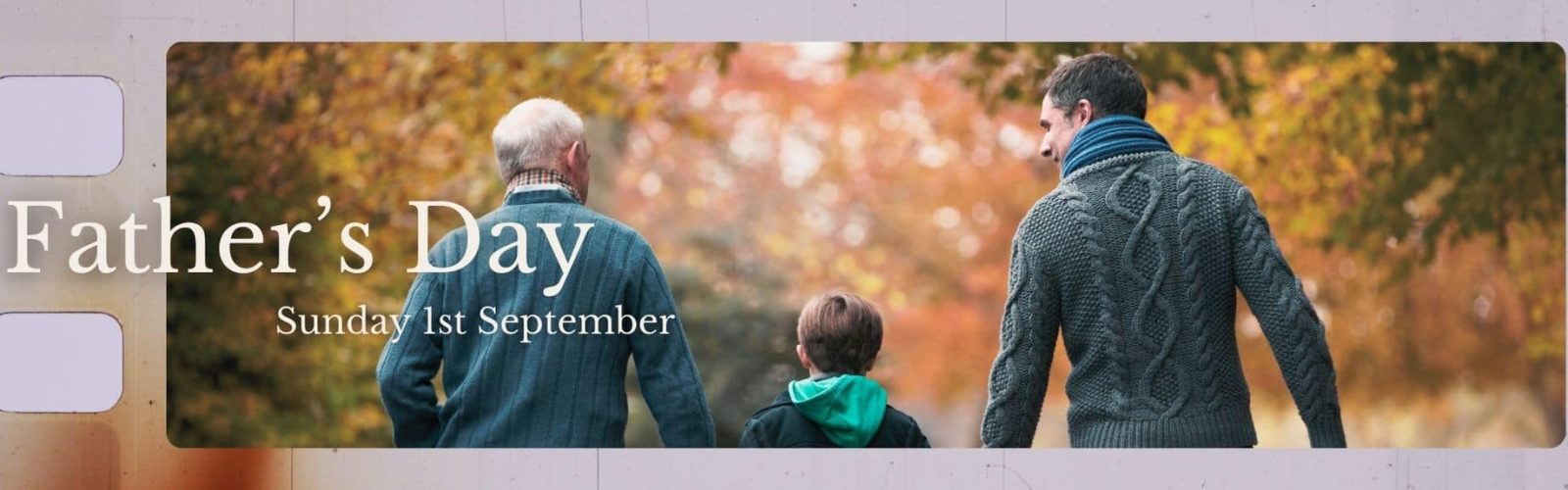 Fathers Day Sunday 1st September. Image of grandpa, adult son and young boy holding hands walking with autumn trees around them.
