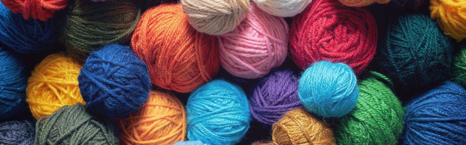 Image of bright coloured balls of wool in a pile