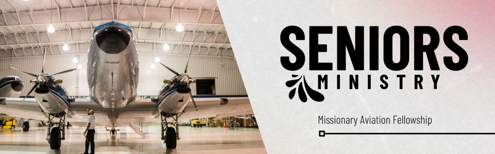 Beautiful old fashioned silver small plane with the piolt looking under it