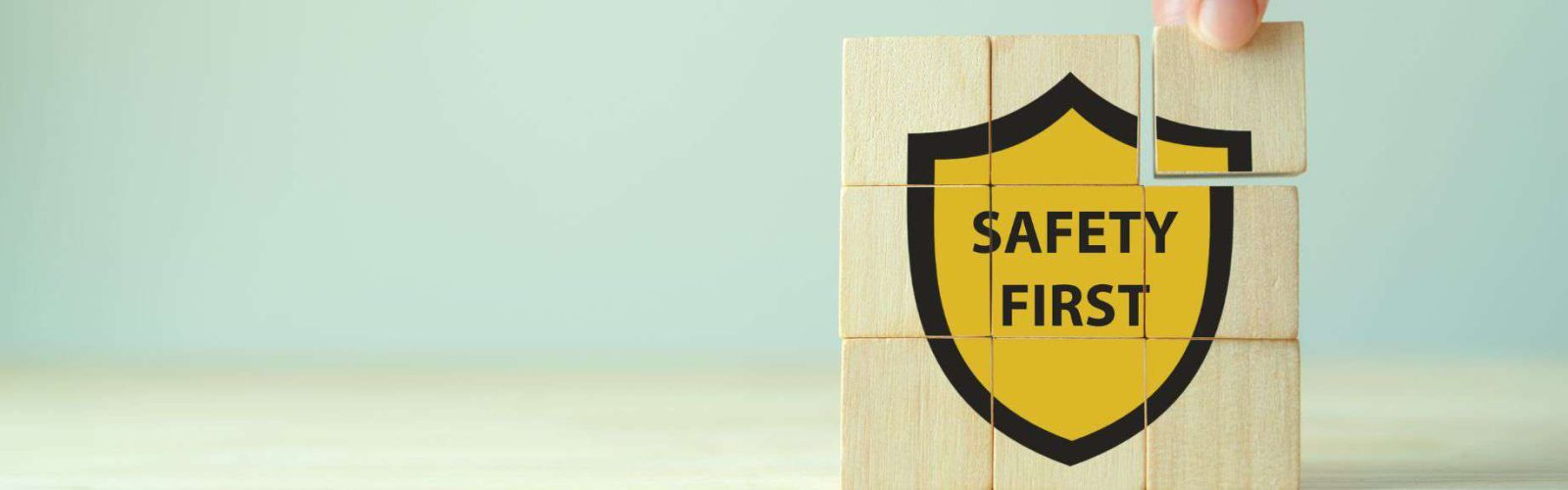 Saftey First plaque. Nine blocks of wood with the wording on them displayed three up.