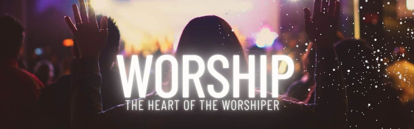 Worship. The heart of the worshiper. Image of a group facing a stage with their arms up praying.